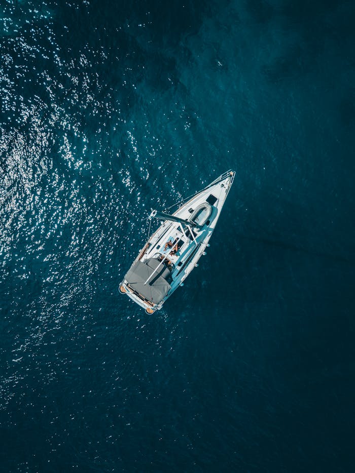 digital A stunning aerial shot of a sailboat cruising the deep blue waters of Croatia.