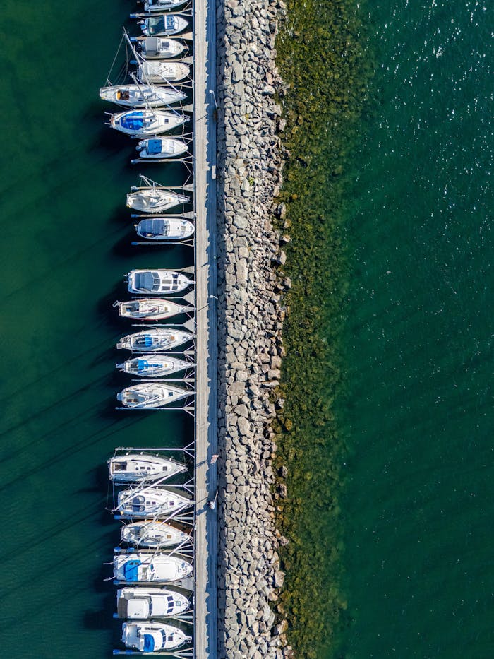 creative-03 Stunning aerial shot of boats docked in Huskvarna Harbor, showcasing clear, azure waters.