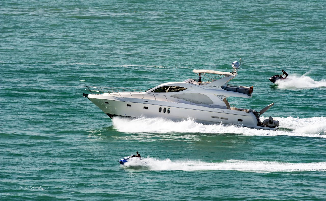 brand-02 A luxury yacht and jet skis cruising on the open sea, depicting speed and adventure.